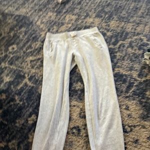 grey sweatpants with a couple buttons